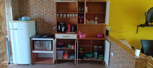 a kitchen with a counter and a refrigerator at Casa Soul de Verão in Ilha Comprida