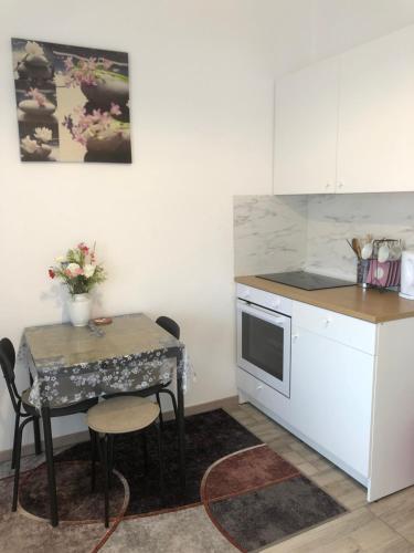 a kitchen with a table and a small table with chairs at Studio Stipe- with free parking, self check-in 0-24 in Zagreb