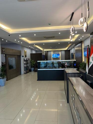 a large lobby with a bar in a hospital at Perlina Hotel Erbil in Erbil