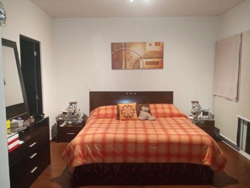 a bedroom with a bed with a teddy bear on it at Depa amueblado y Bonita in Buenavista
