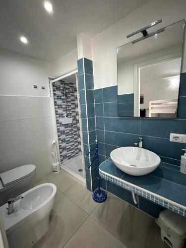 a bathroom with a sink and a toilet and a mirror at PalmaPiana in Ponza