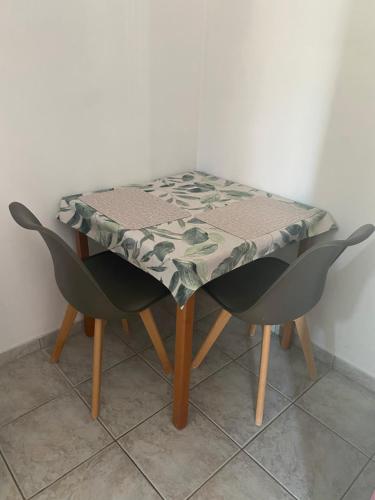 a table with a table cloth on it with two chairs at Annalisa Studio & Apartments in Skala Kefalonias
