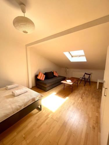 a bedroom with a bed and a couch in a room at Agapella Apartamemty- Villa Agapella 250m from the beach in Sopot