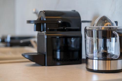 a coffee maker sitting on a counter next to a blender at Aeli Vista Apartments in Neos Marmaras
