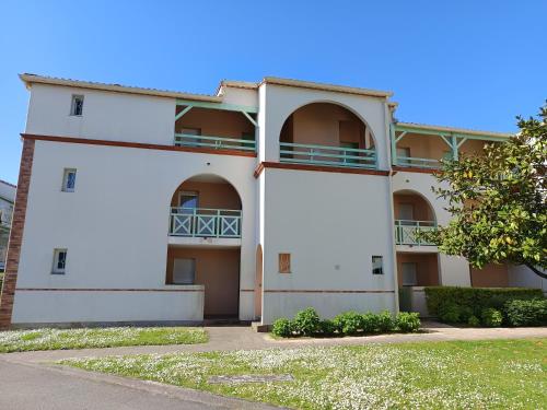 a white building with balconies on it at T2 Parc du Golf in Pornic