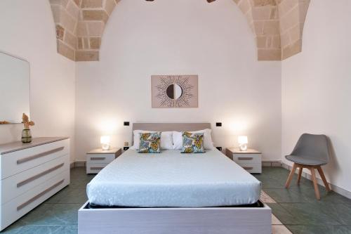 a white bedroom with a bed and two night stands at Sardinia 10 Apartment - Lecce Selection in Lecce
