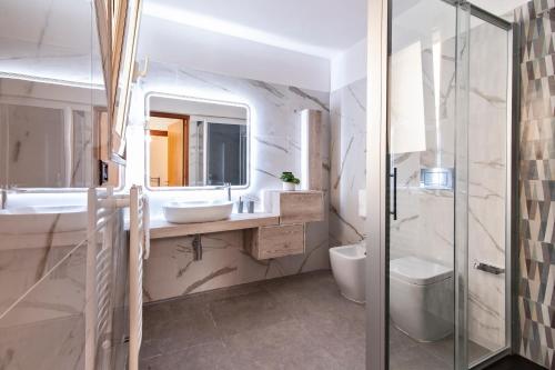 a bathroom with a sink and a toilet and a mirror at Sardinia 10 Apartment - Lecce Selection in Lecce