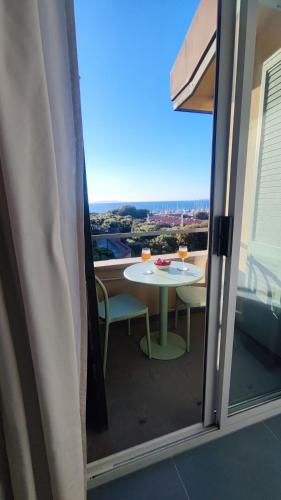 a table and chairs on a balcony with a view at Bellavista Punta Ala in Punta Ala