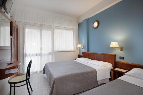 Postel nebo postele na pokoji v ubytování Hotel Avana Fronte Mare