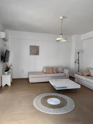 a living room with a couch and a coffee table at Dimora Miranda in Agios Prokopios