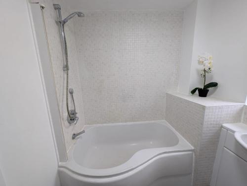 a white bathroom with a shower and a toilet at Spacious Large 4 Bed Contractor in Dallington