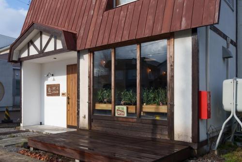 a store front with a wooden door and windows at YUKARA LEAF OLDGE - Vacation STAY 29791v in Ōnuma