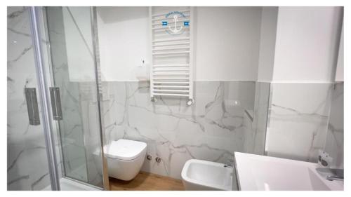 a bathroom with a shower and a toilet and a sink at Ostia Holiday La Dolce Sosta Executive in Lido di Ostia