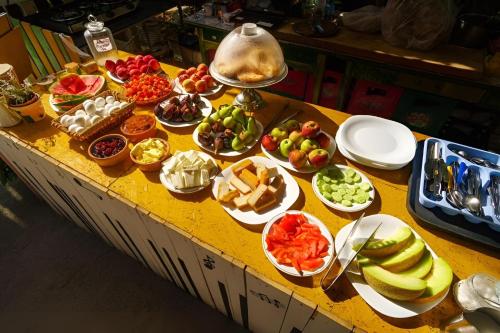 a table filled with different types of fruits and vegetables at Tirana Backpacker Hostel in Tirana