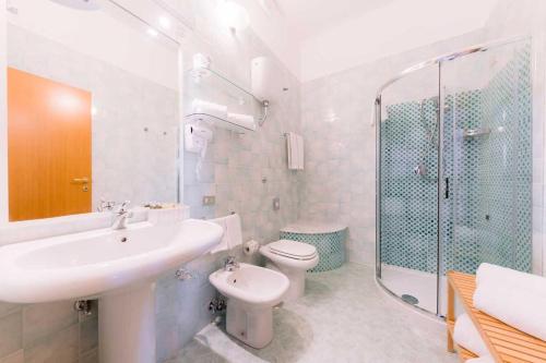 a bathroom with a sink and a toilet and a shower at Villa San Lorenzo in Scala