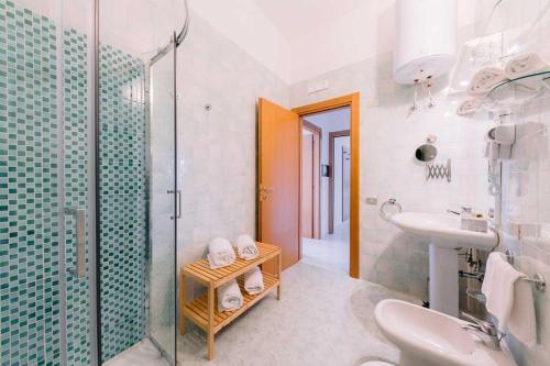 a bathroom with a sink and a glass shower at Villa San Lorenzo in Scala