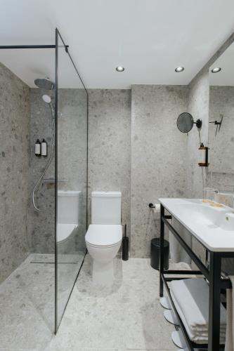 a bathroom with a toilet and a sink at Odysseia Hotel Kapetanios in Limassol