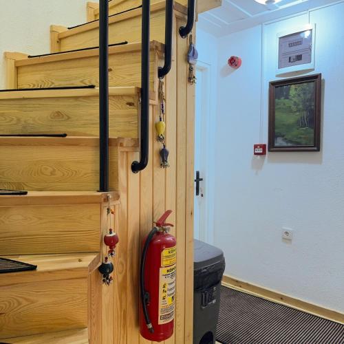 a fire hydrant hanging from a wooden door in a room at Hera Pansiyon in Ayvalık