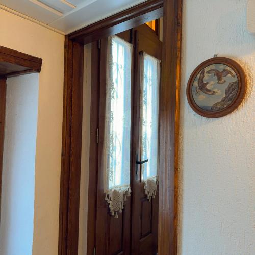 a wooden door with a mirror on a wall at Hera Pansiyon in Ayvalık