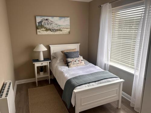 a small bedroom with a bed and a window at Seafront Apartment in Tramore in Tramore