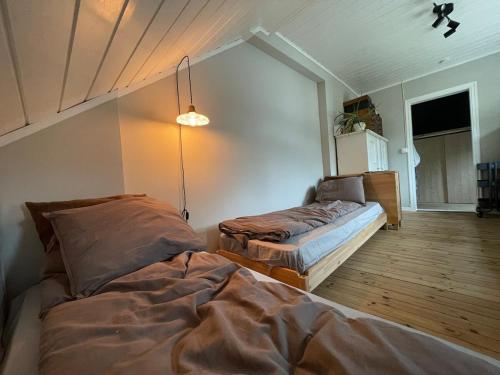 a bedroom with two beds in a room at Unikt skipperhus med høner i hagen in Hvaler