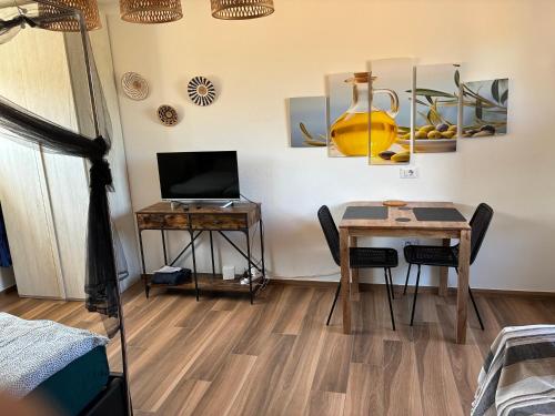 a room with a table and a desk with a laptop at Terra in Valledoria