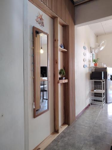 a hallway with a mirror and a dining room at La casita de Nana in Esparza