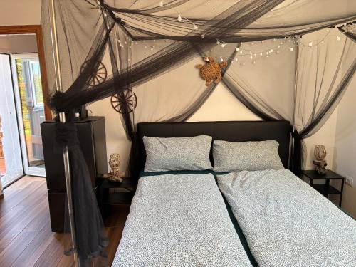 a bedroom with a bed with a canopy at Terra in Valledoria