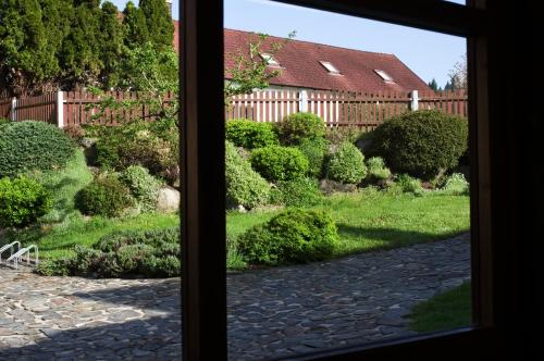a window view of a garden from a house at Mlýn Kamenice in Klučenice