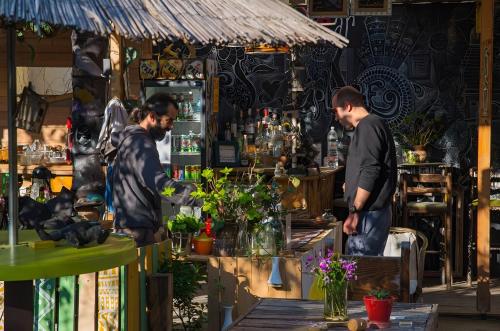 two men are standing in a shop with flowers at Tirana Backpacker Hostel in Tirana