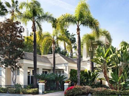 a house with palm trees in front of it at CLOUD NINE - Elegance & Comfort in Irvine