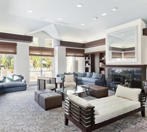 a living room with blue furniture and a fireplace at CLOUD NINE - Elegance & Comfort in Irvine
