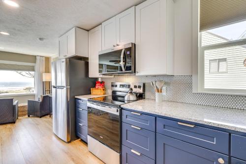 a kitchen with blue cabinets and a window at Walk to Winema Road Beach Home with Hot Tub! in Cloverdale