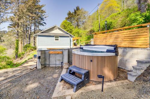 a hot tub and a chair next to a house at Walk to Winema Road Beach Home with Hot Tub! in Cloverdale
