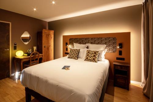 Postel nebo postele na pokoji v ubytování Logis Hôtel Jeanne & Jules Hôtel Spa et Restaurant