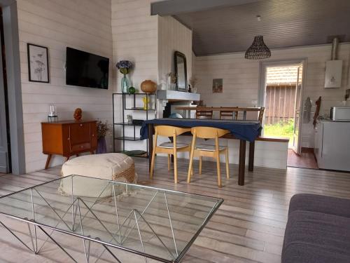 un salon avec une table bleue et des chaises dans l'établissement Charming garden house, à Bias