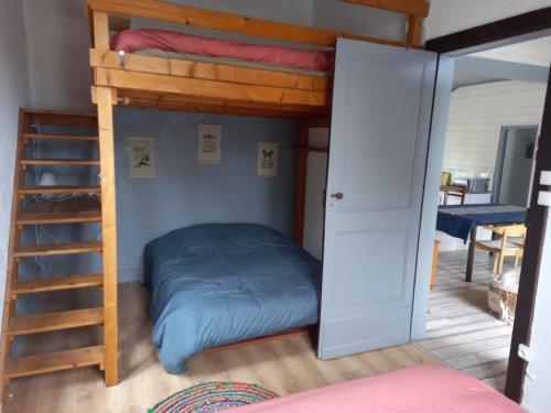 une chambre avec un lit superposé et une échelle dans l'établissement Charming garden house, à Bias