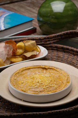 a table with two plates of food and a pie at Nekajui, a Ritz-Carlton Reserve in Papagayo, Guanacaste