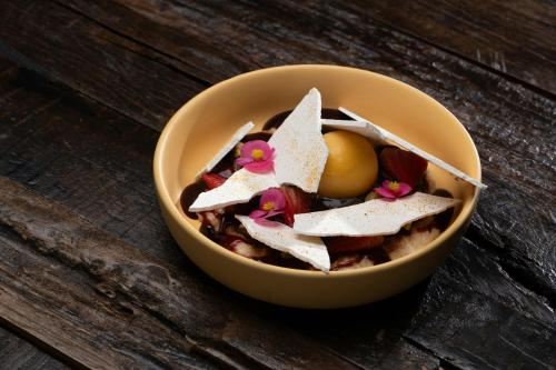 a bowl of food with an egg in it at Nekajui, a Ritz-Carlton Reserve in Papagayo, Guanacaste