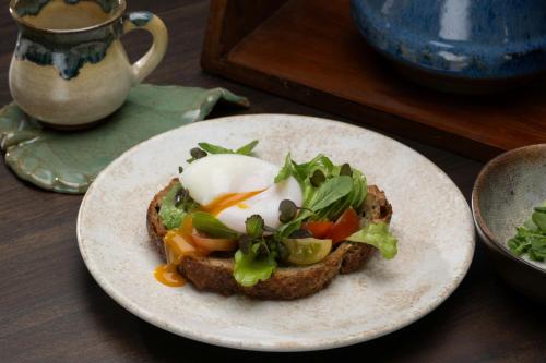 a piece of bread with an egg on top on a plate at Nekajui, a Ritz-Carlton Reserve in Papagayo, Guanacaste