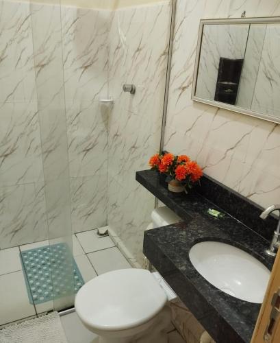 a bathroom with a toilet and a sink and a mirror at Kitnet linda 8A in Montes Claros