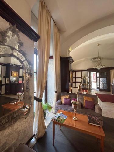 a living room with a couch and a table at Hotel Am Schubertring in Vienna