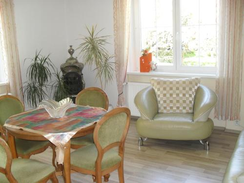 a living room with a table and chairs and a couch at Pension Rak in Karlovy Vary