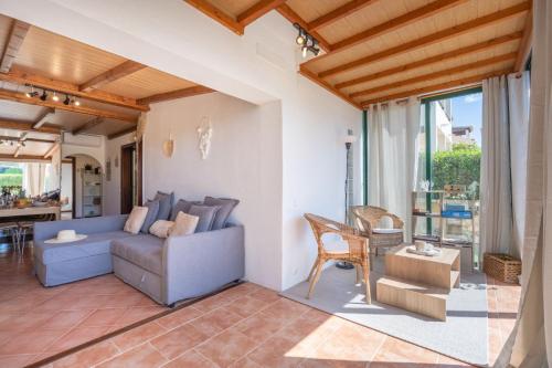 a living room with a couch and a table at The Golden Breeze – Beachside Pool & BBQ Escape in Faro