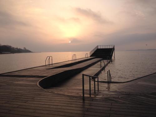 a dock on the water with the sunset in the background at Byhus i Faaborg in Fåborg