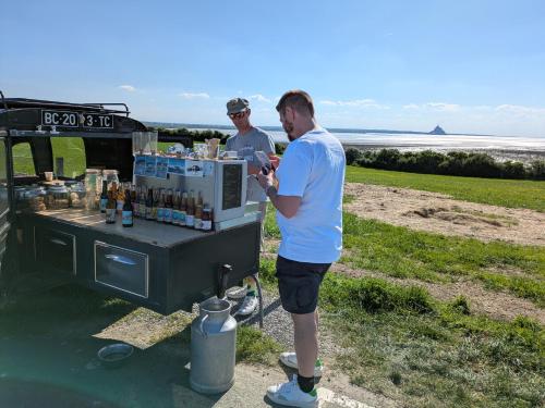 two men standing in front of a food cart at La Jeannette in Vains