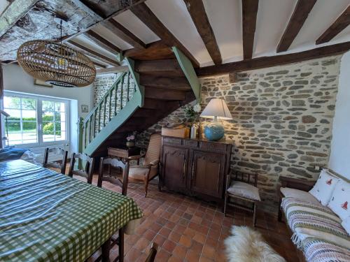 a room with a bed and a staircase in a house at La Jeannette in Vains