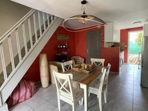 une salle à manger avec une table et un escalier dans l'établissement Charmant pavillon avec piscine à Valras-Plage, proche plage et commerces, idéal pour 4 personnes - FR-1-701-78, à Valras-Plage