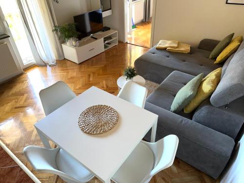 a living room with a table and a couch at Apartment Marino in Senj