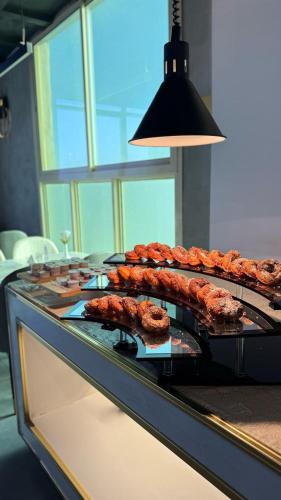 a buffet with meats and pastries on a counter at SEAVIEW HOTEL in Umm Lujj